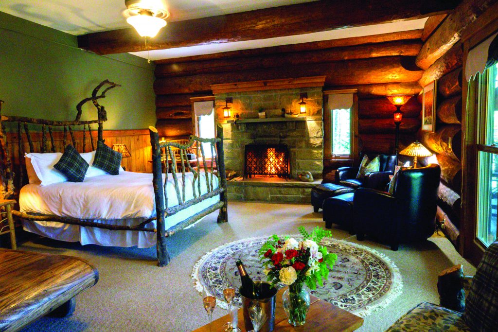 A fire-lit bedroom in a luxurious lodge