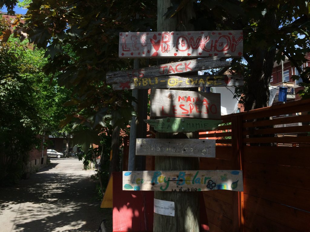 Handmade signs mark the beginning of an alleyway.